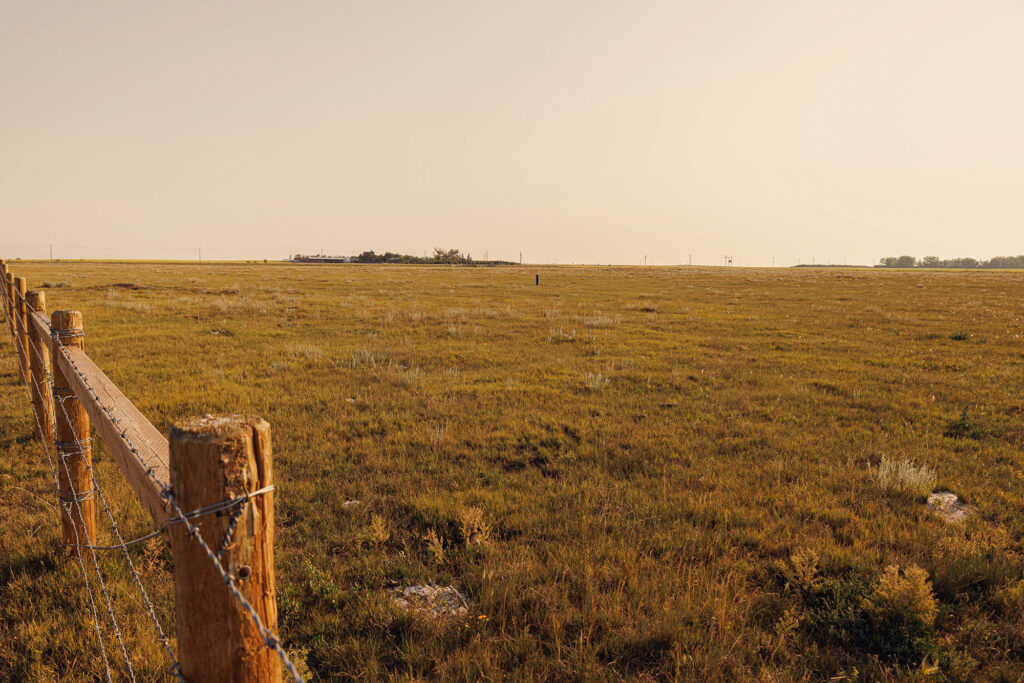 McKay Lands Parcel 1 - A wire and wooden fence runs along the perimeter of a grassy piece of farm land