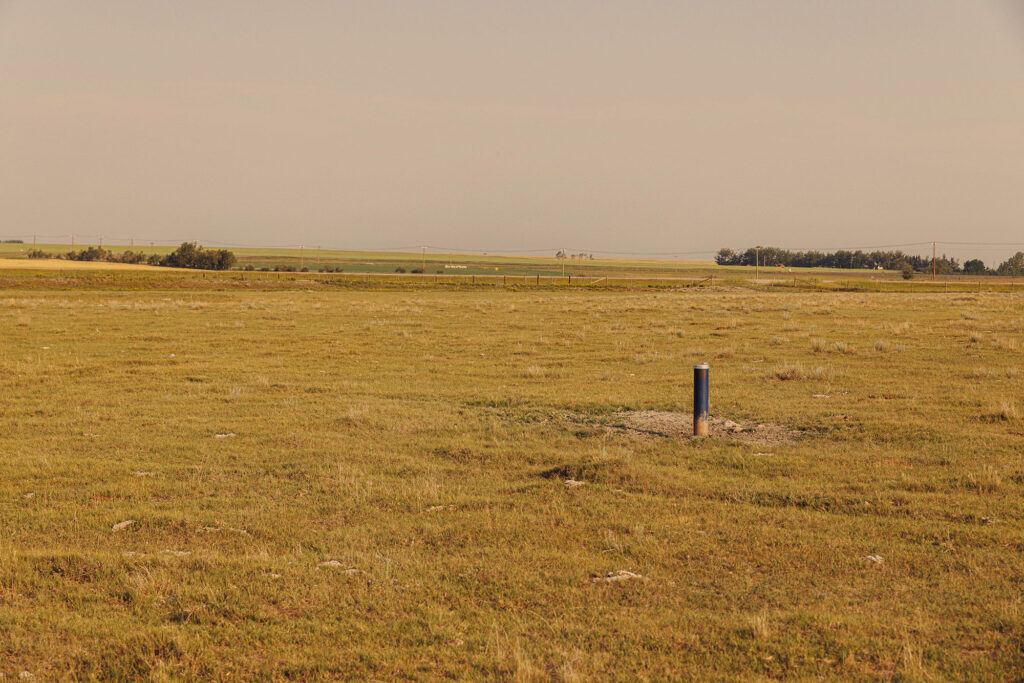 McKay Lands Parcel 1 - A blue pole is sticking out of dirt mound in the middle of a large piece of farmland