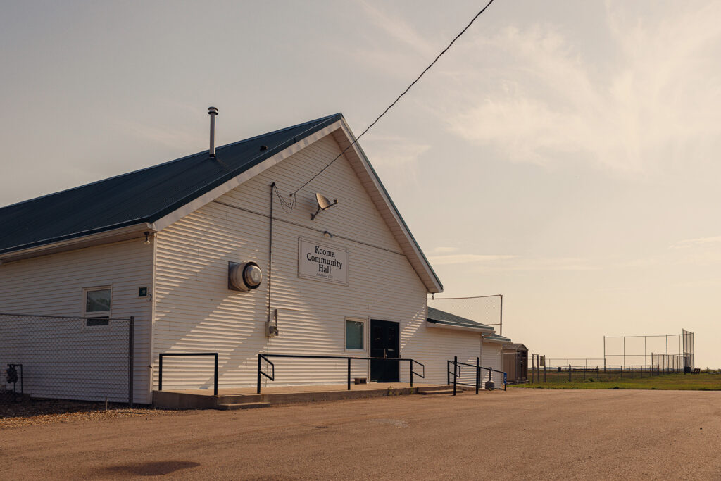 McKay Lands Community - A sign that reads Keoma Community Hall is on a white building with a black roof